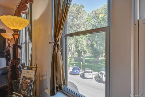 a view of a room with a large window and chair