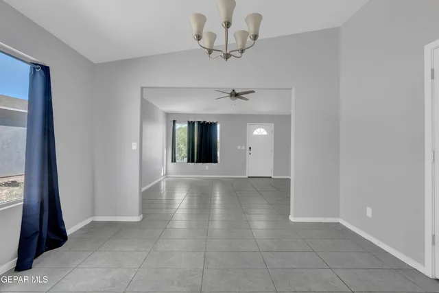 a view of an empty room and a bathroom