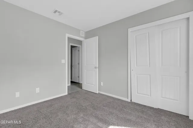 a view of an empty room and closet area