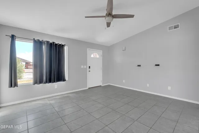 a view of an empty room with a window