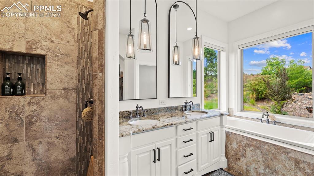 13625 Random Ridge View Colorado Springs, CO 80921 - Photo 20 of 50 Full bathroom featuring walk in shower, a bath, and double vanity