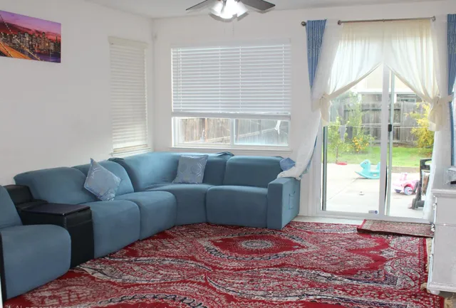 a living room with furniture and a large window