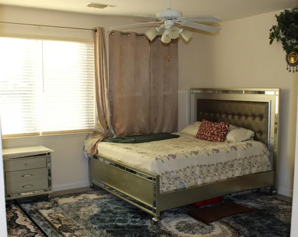 a bedroom with a bed and a window