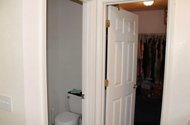 a bathroom with a toilet and a shower