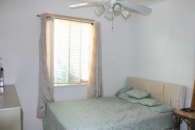 a bedroom with a bed and a window