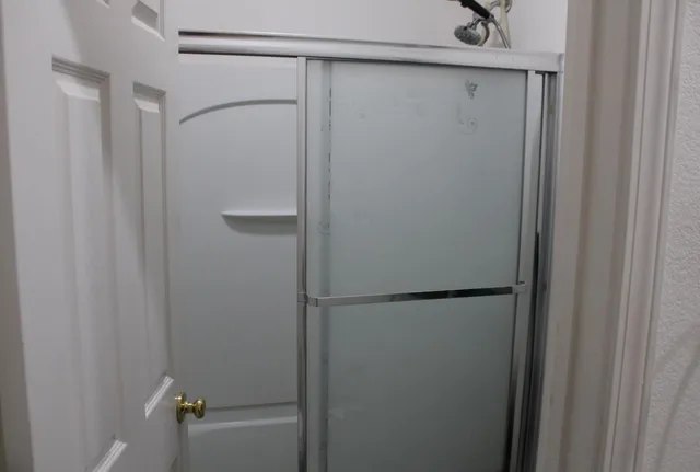 a bathroom with a glass shower door