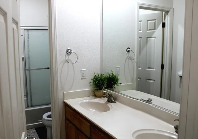 a bathroom with a sink toilet and shower