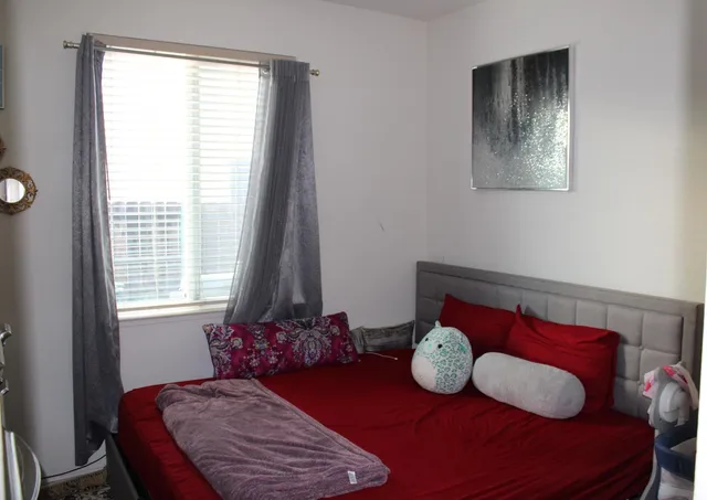 a bedroom with a bed and window