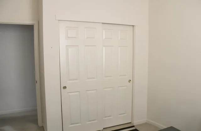 a small space with a window and a potted plant