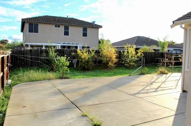 a view of balcony with wooden floor and fence
