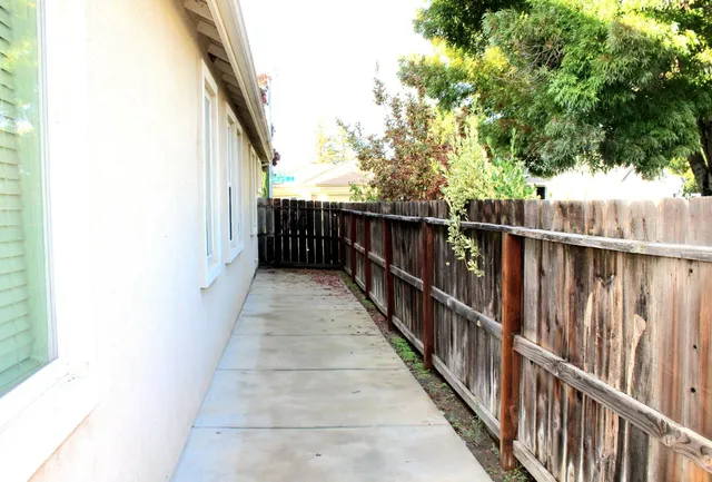 a view of a dining room with furniture and a chandelier