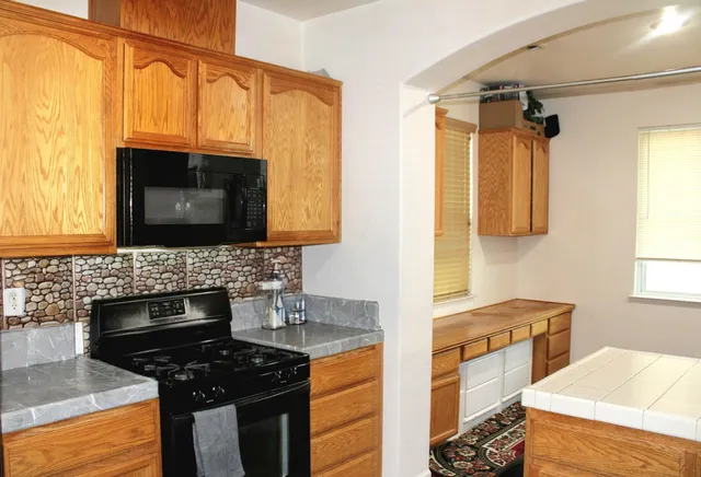 a kitchen with a stove a sink and a microwave