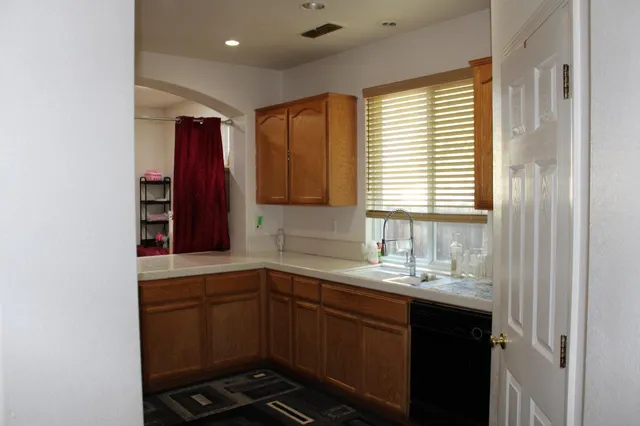 a front view of a house with a garden and yard