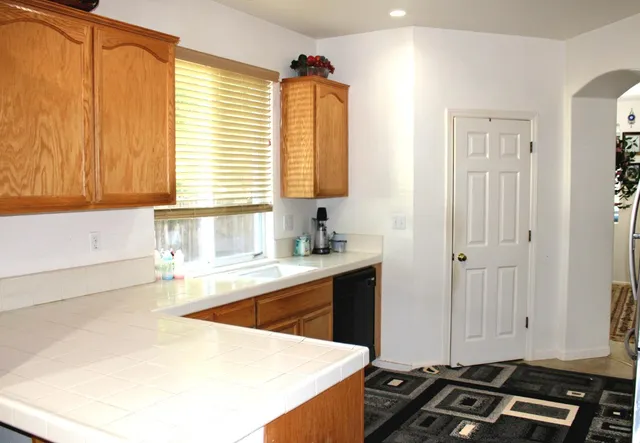 a kitchen with sink refrigerator and window