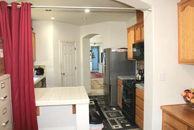 a kitchen with a refrigerator and a stove