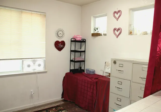 a bedroom with a dresser and a window