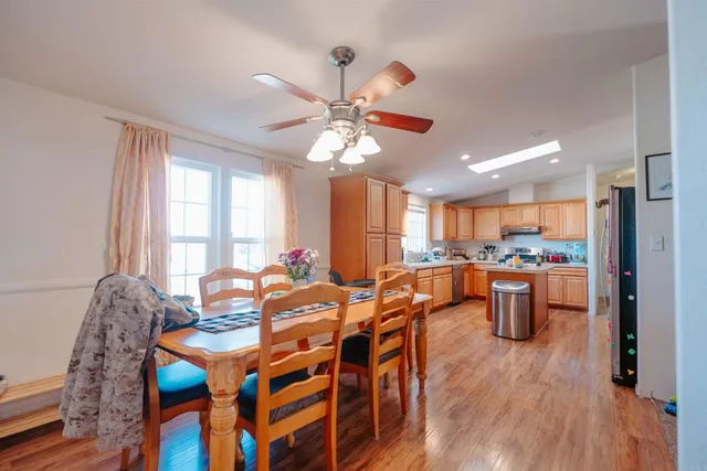 a view of a dining room with furniture window and wooden floor