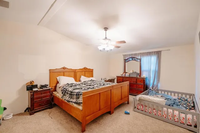 a bedroom with bed and a chandelier