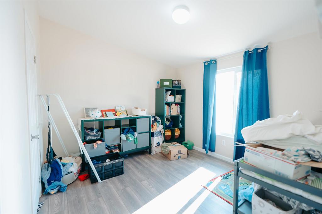 4740 Flying H Road Twentynine Palms, CA 92277 - Photo 8 of 19 a bedroom with furniture and a wooden floor