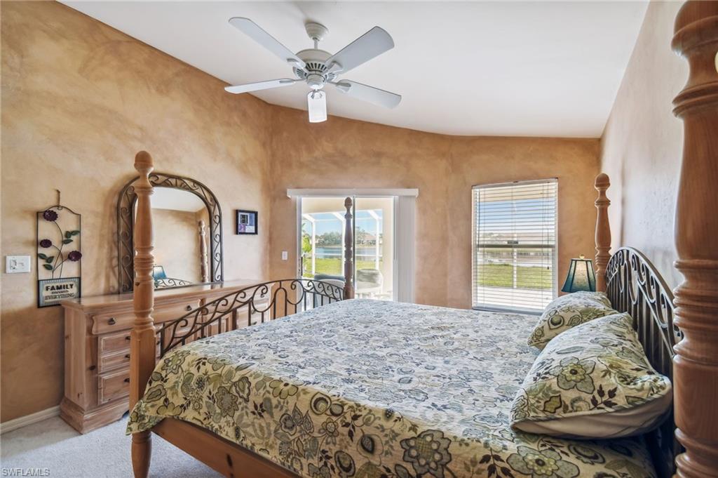 21629 Windham Run Estero, FL 33928 - Photo 11 of 23 a bedroom with a bed a large window with the potted plants