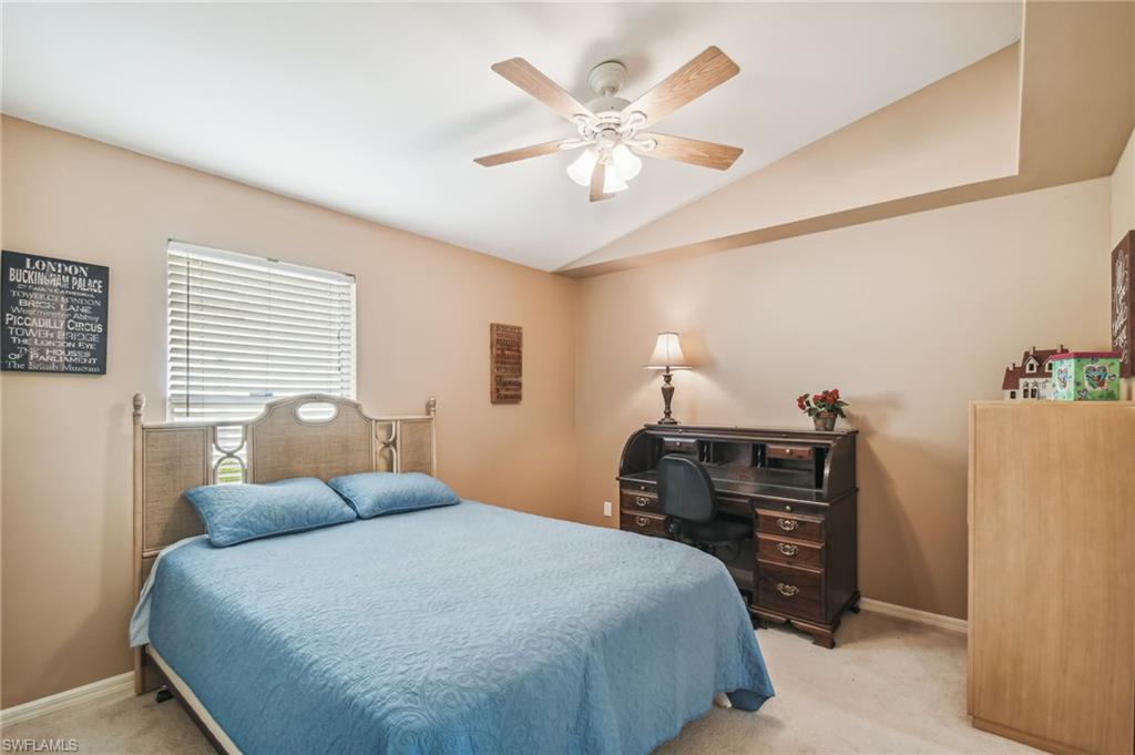 21629 Windham Run Estero, FL 33928 - Photo 13 of 23 a bedroom with a bed and a chandelier