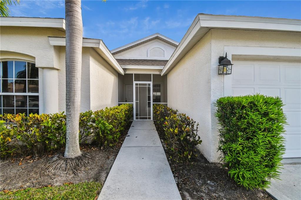 21629 Windham Run Estero, FL 33928 - Photo 2 of 23 a front view of a house with garden