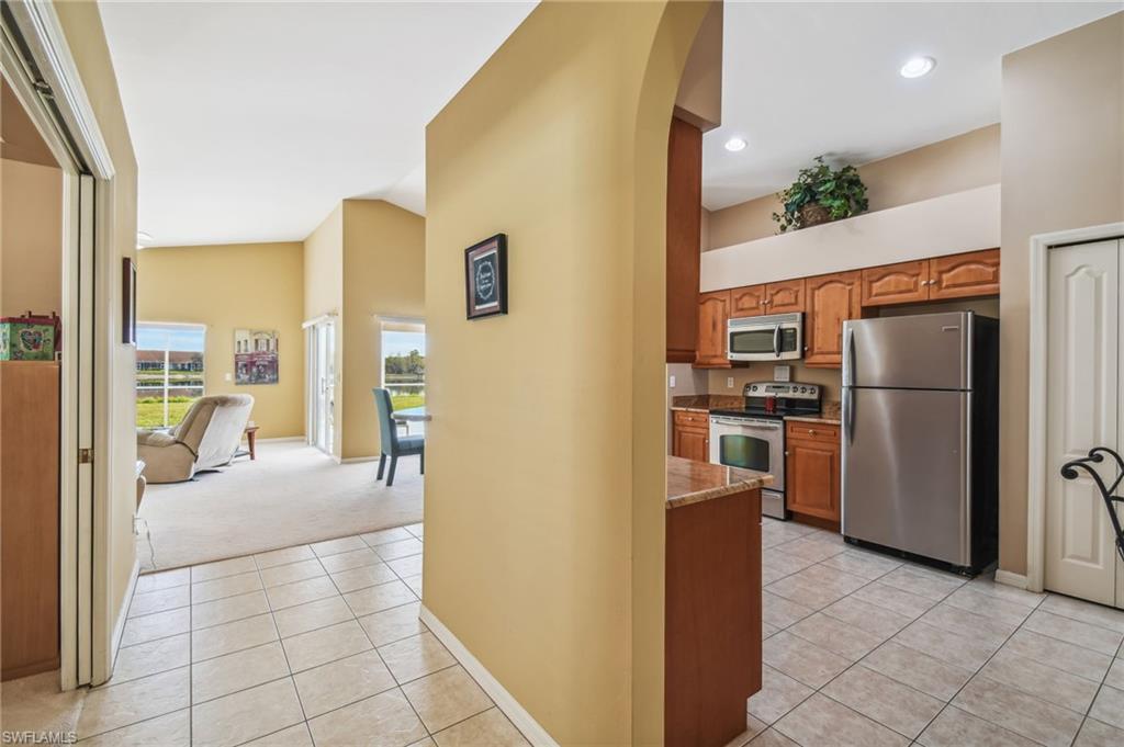 21629 Windham Run Estero, FL 33928 - Photo 3 of 23 a kitchen with refrigerator and table