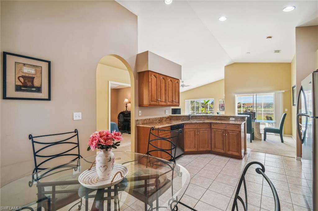21629 Windham Run Estero, FL 33928 - Photo 5 of 23 a kitchen with granite countertop kitchen island stainless steel appliances a sink and cabinets
