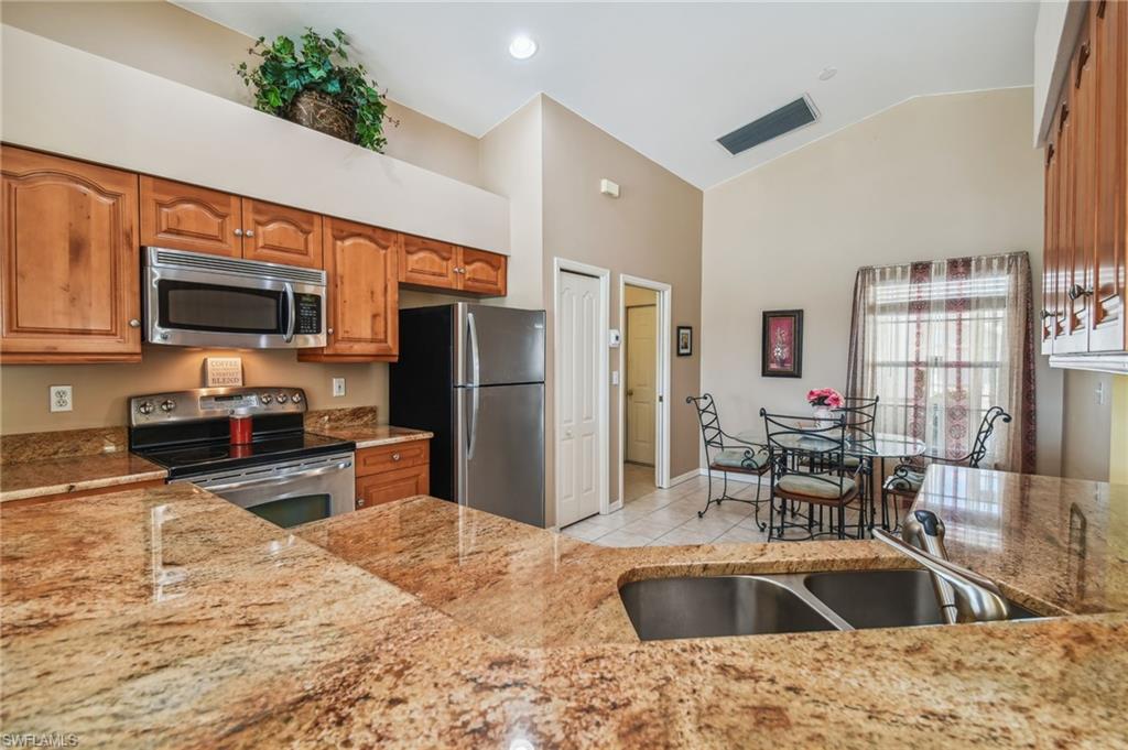 21629 Windham Run Estero, FL 33928 - Photo 6 of 23 a kitchen with a refrigerator sink and microwave