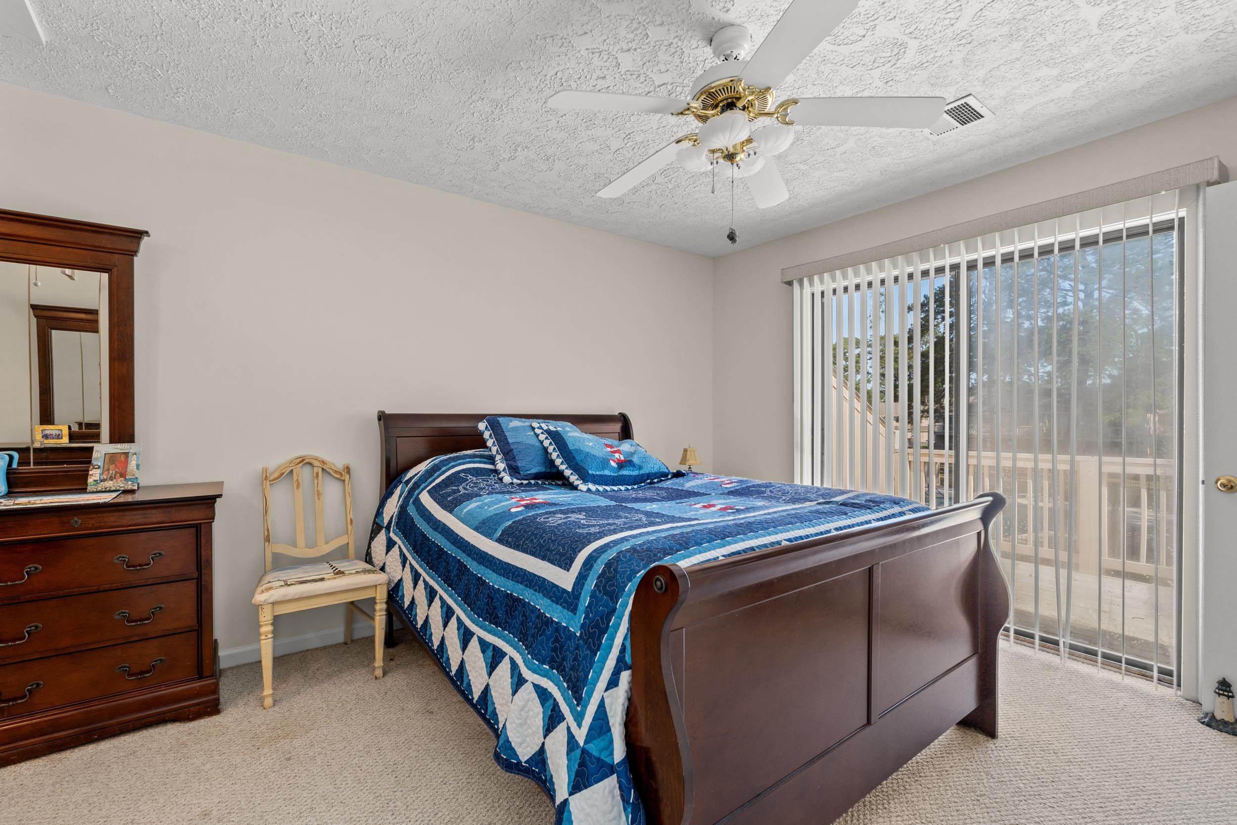 3015 Old Bryan Drive, Unit 97 Myrtle Beach, SC 29577 - Photo 14 of 35 Bedroom with access to outside, light colored carpet, visible vents, and a textured ceiling