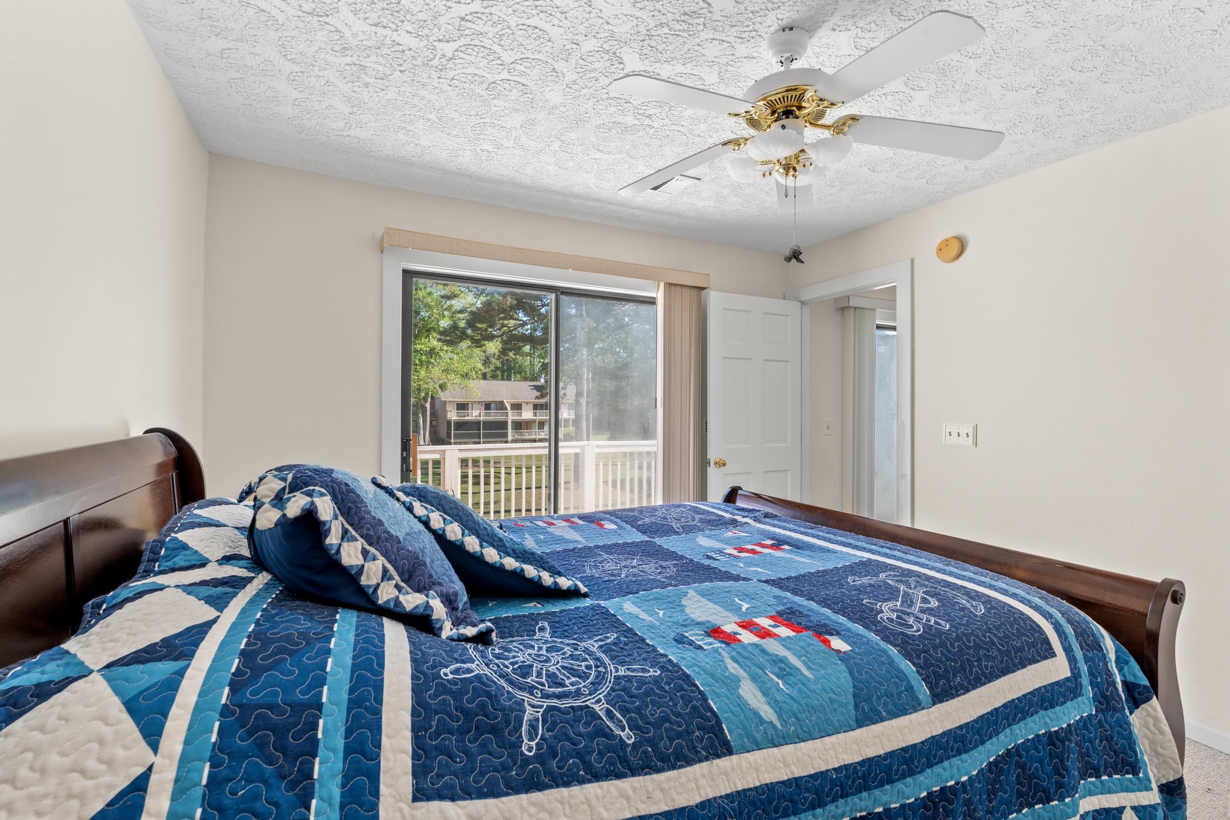 3015 Old Bryan Drive, Unit 97 Myrtle Beach, SC 29577 - Photo 17 of 35 Bedroom featuring a textured ceiling and ceiling fan