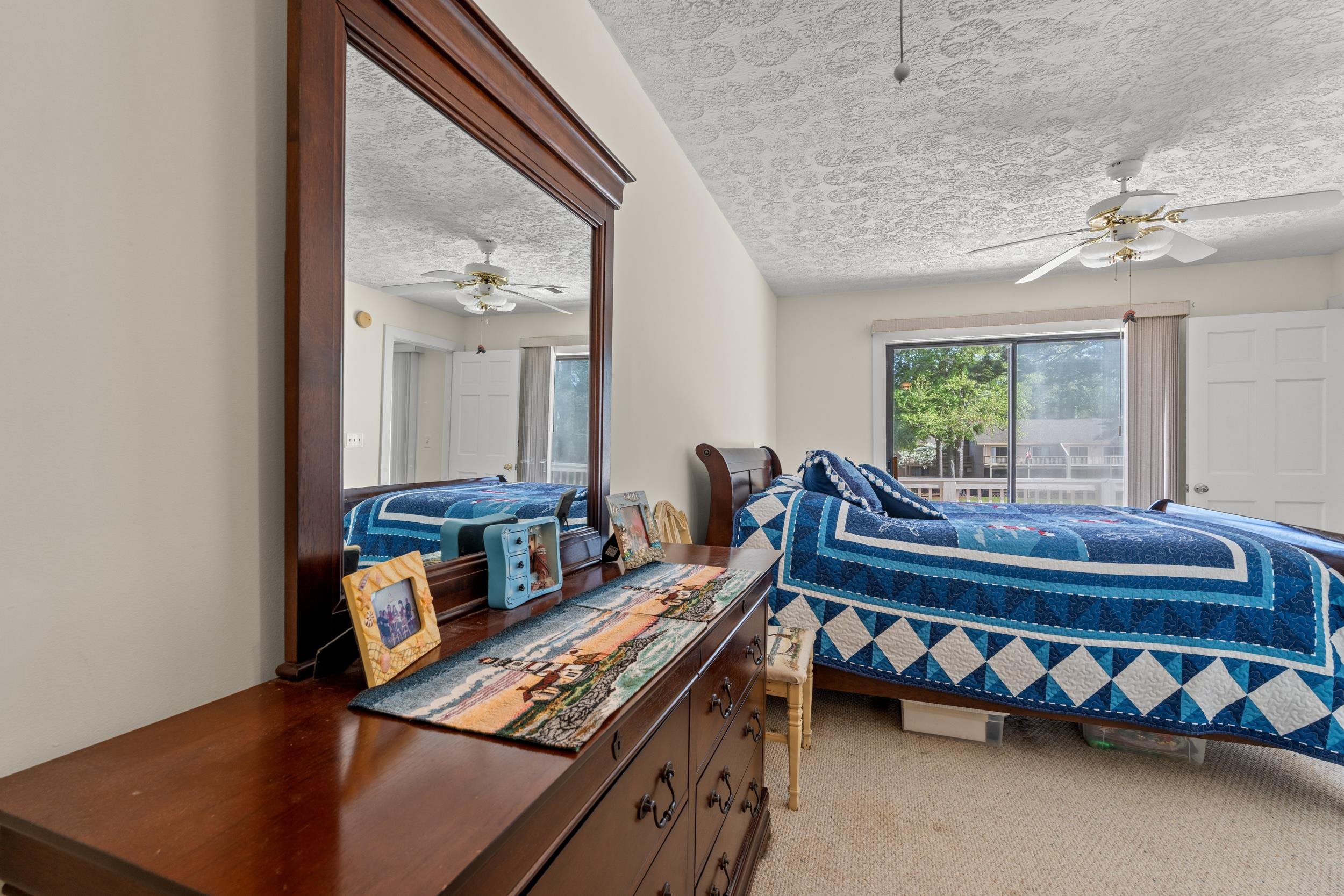 3015 Old Bryan Drive, Unit 97 Myrtle Beach, SC 29577 - Photo 18 of 35 Bedroom featuring carpet flooring, a textured ceiling, and a ceiling fan