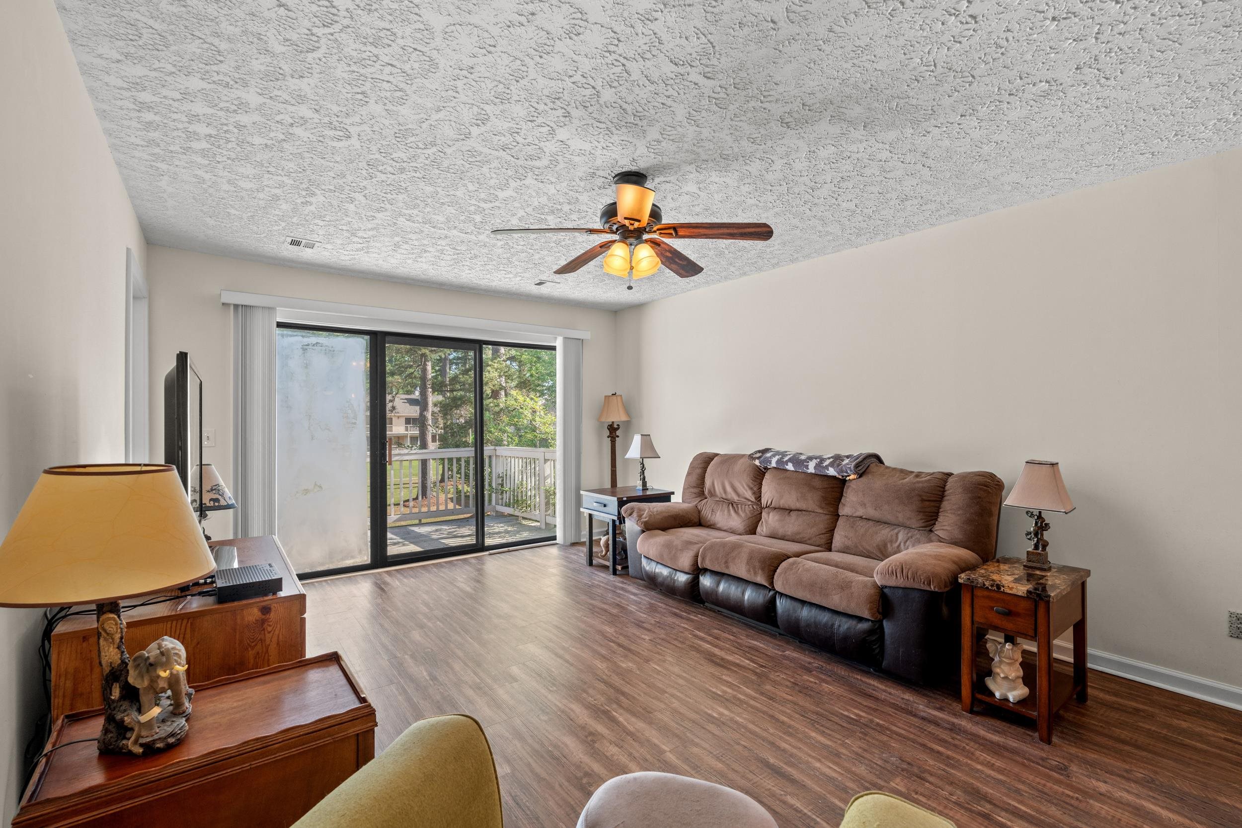 3015 Old Bryan Drive, Unit 97 Myrtle Beach, SC 29577 - Photo 3 of 35 Living area with a textured ceiling, wood finished floors, ceiling fan, and baseboards