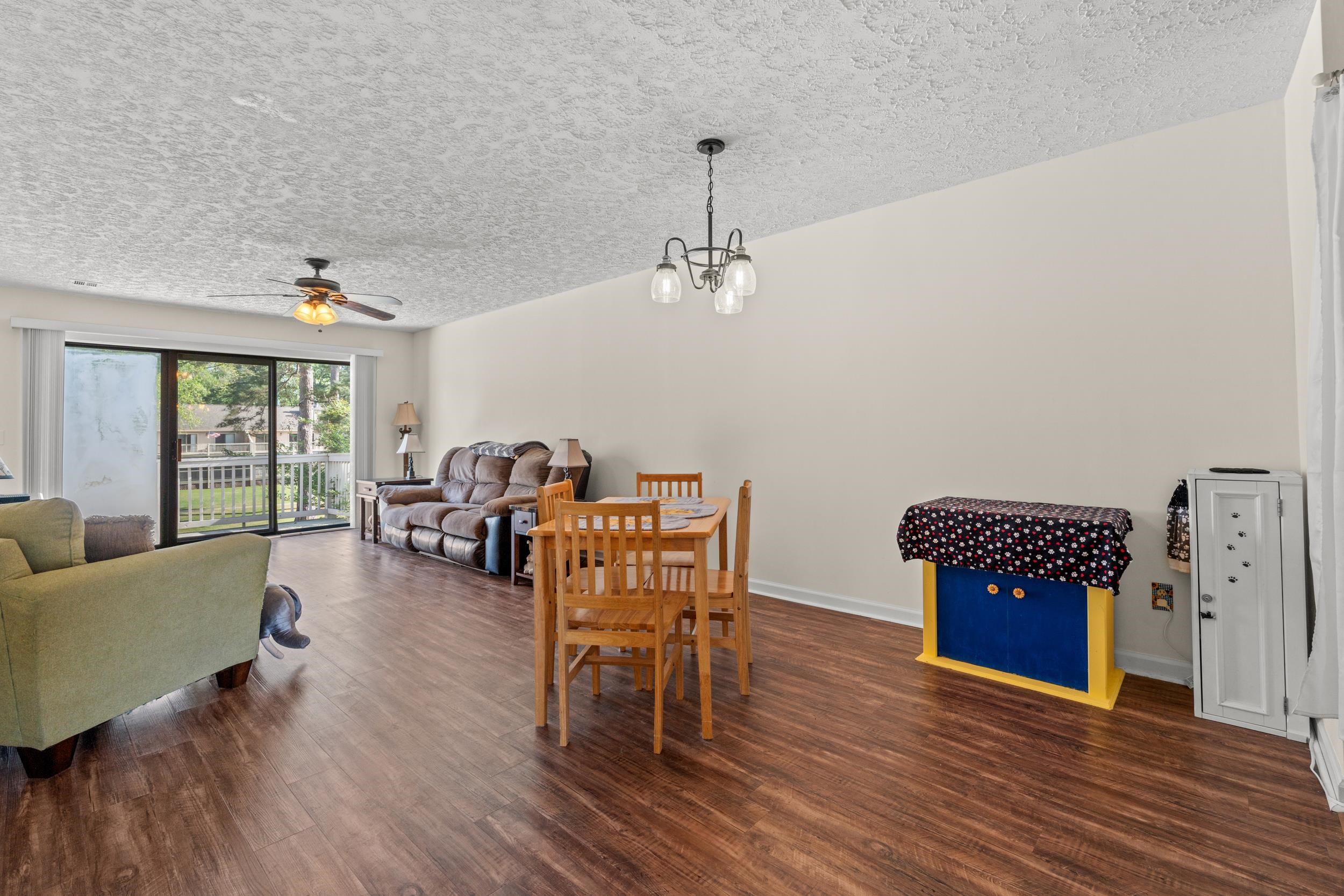 3015 Old Bryan Drive, Unit 97 Myrtle Beach, SC 29577 - Photo 5 of 35 Dining room with ceiling fan, baseboards, a textured ceiling, and wood finished floors