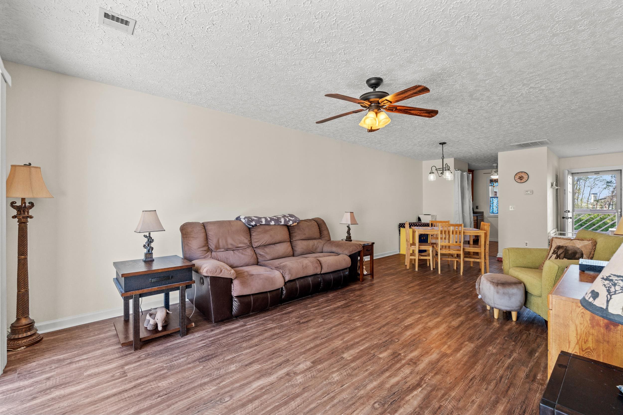3015 Old Bryan Drive, Unit 97 Myrtle Beach, SC 29577 - Photo 9 of 35 Living room with visible vents, baseboards, wood finished floors, and ceiling fan with notable chandelier