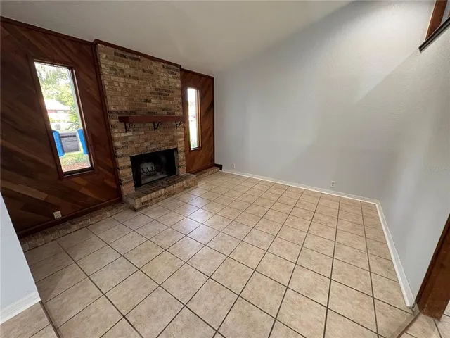 a view of an empty room and fire place