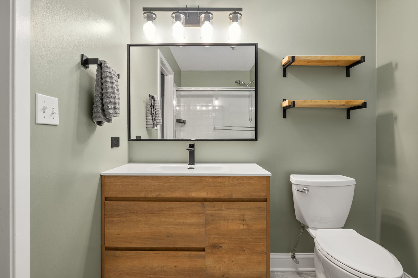 933 West Van Buren Street, Unit 508 Chicago, IL 60607 - Photo 11 of 25 a bathroom with a toilet sink and mirror