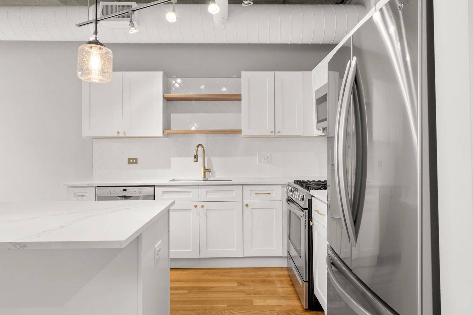 933 West Van Buren Street, Unit 508 Chicago, IL 60607 - Photo 12 of 25 a kitchen with stainless steel appliances a refrigerator sink and cabinets
