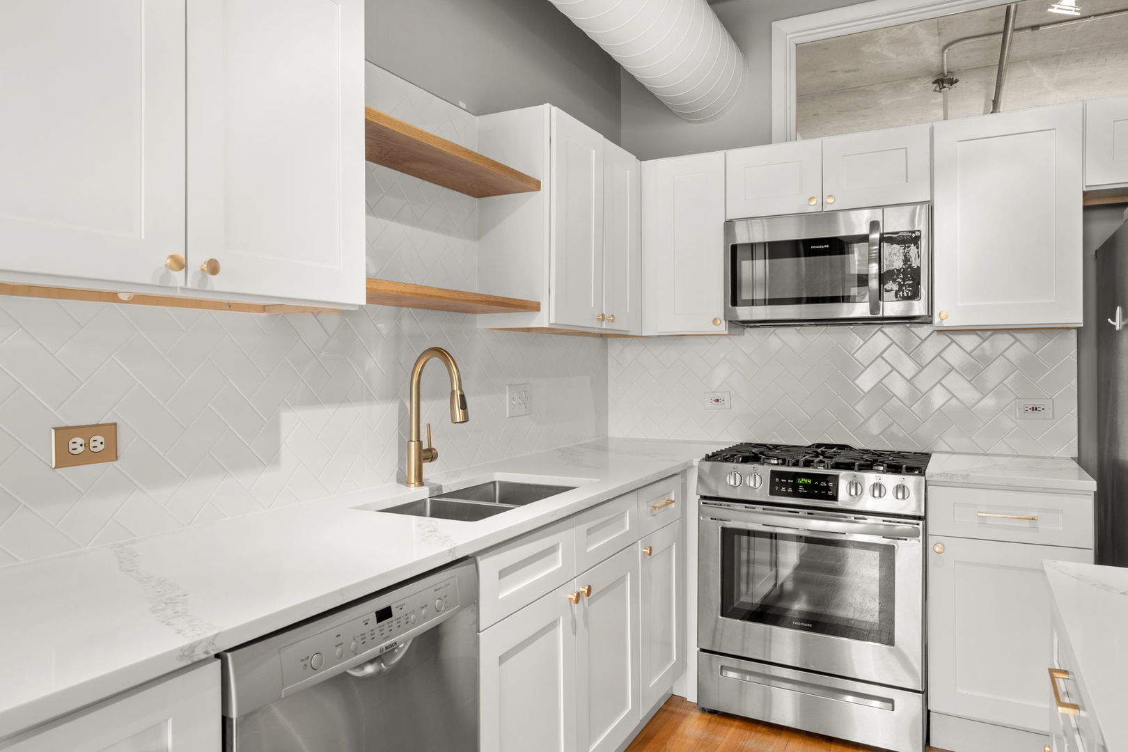 933 West Van Buren Street, Unit 508 Chicago, IL 60607 - Photo 13 of 25 a kitchen with stainless steel appliances granite countertop white cabinets a sink and dishwasher