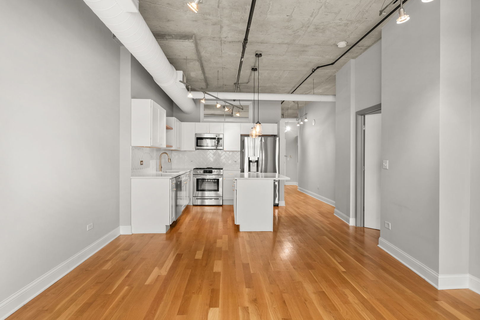 933 West Van Buren Street, Unit 508 Chicago, IL 60607 - Photo 15 of 25 a view of a kitchen with wooden floor