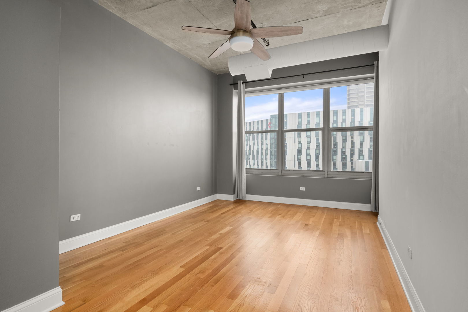 933 West Van Buren Street, Unit 508 Chicago, IL 60607 - Photo 21 of 25 wooden floor in an empty room with a window