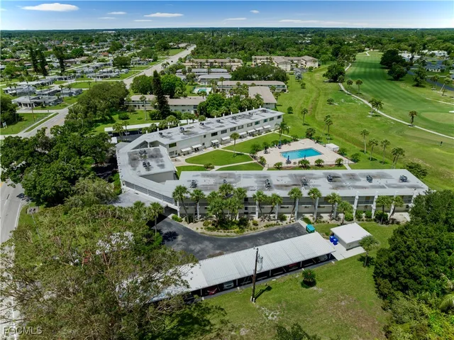 an aerial view of a house with a yard basket ball court and outdoor seating