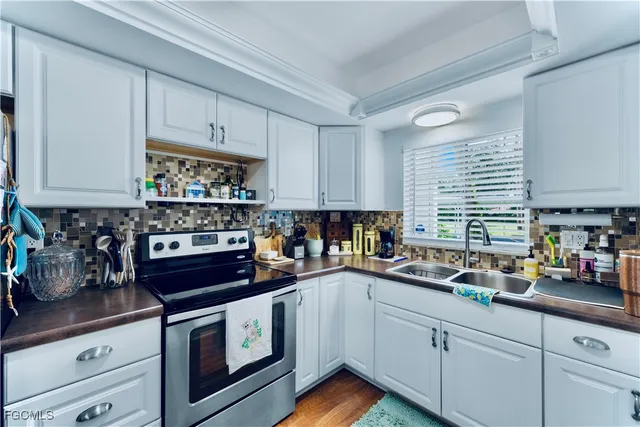 a kitchen with cabinets appliances a sink and a counter top space