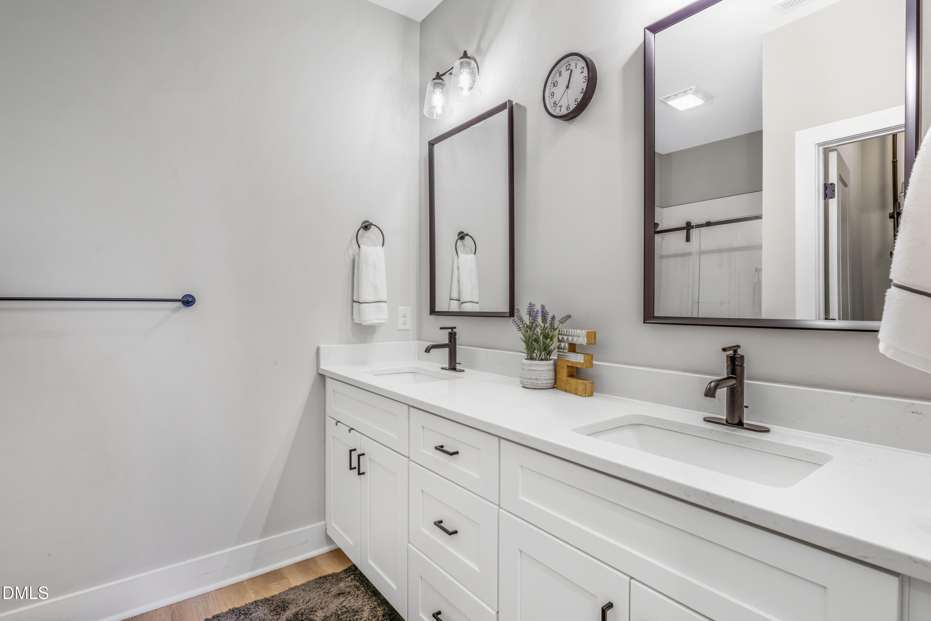 6039 Farmwood Loop Wilson, NC 27896 - Photo 16 of 27 a bathroom with a double vanity sink and a mirror