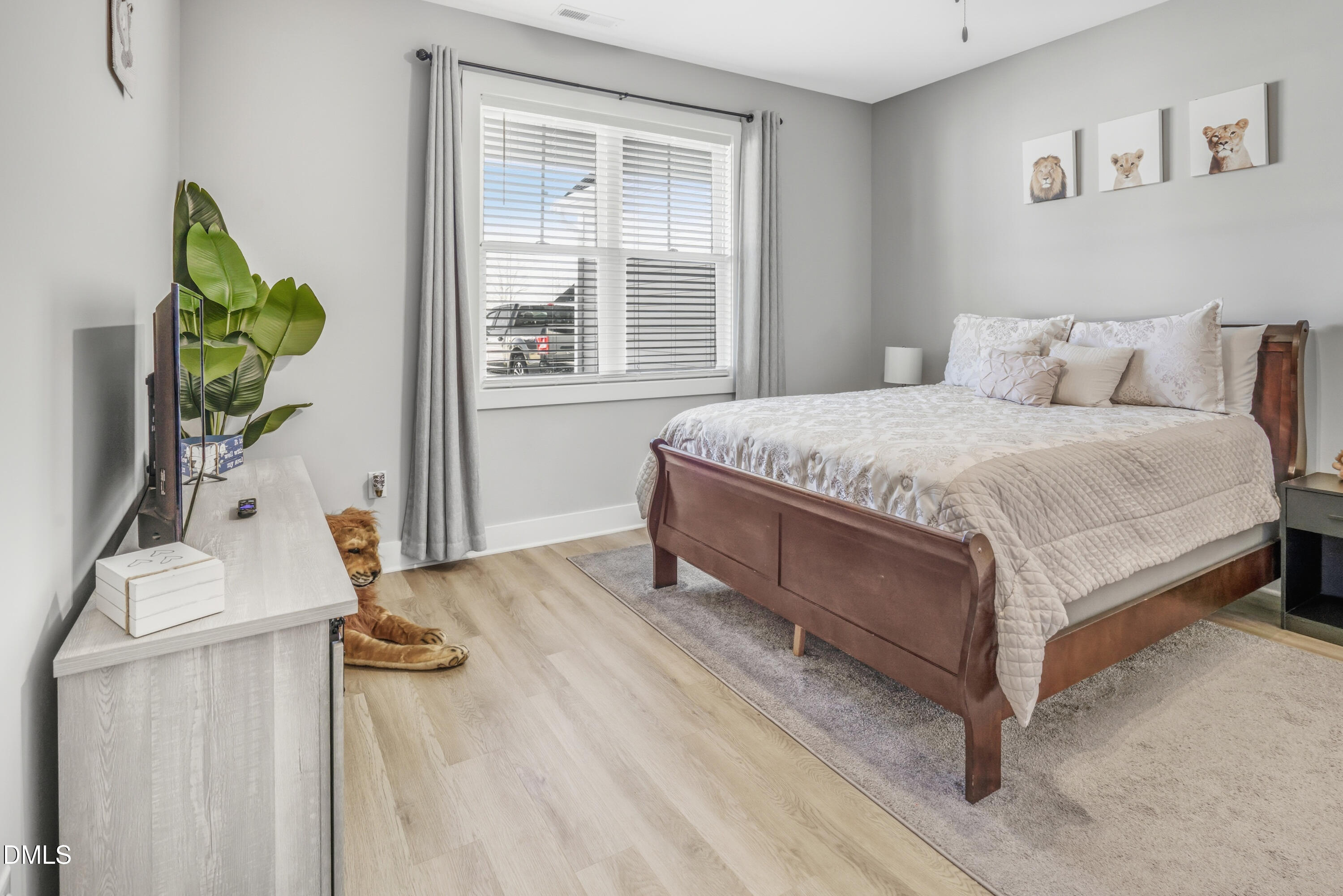 6039 Farmwood Loop Wilson, NC 27896 - Photo 17 of 27 a bed sitting in a bedroom next to a window