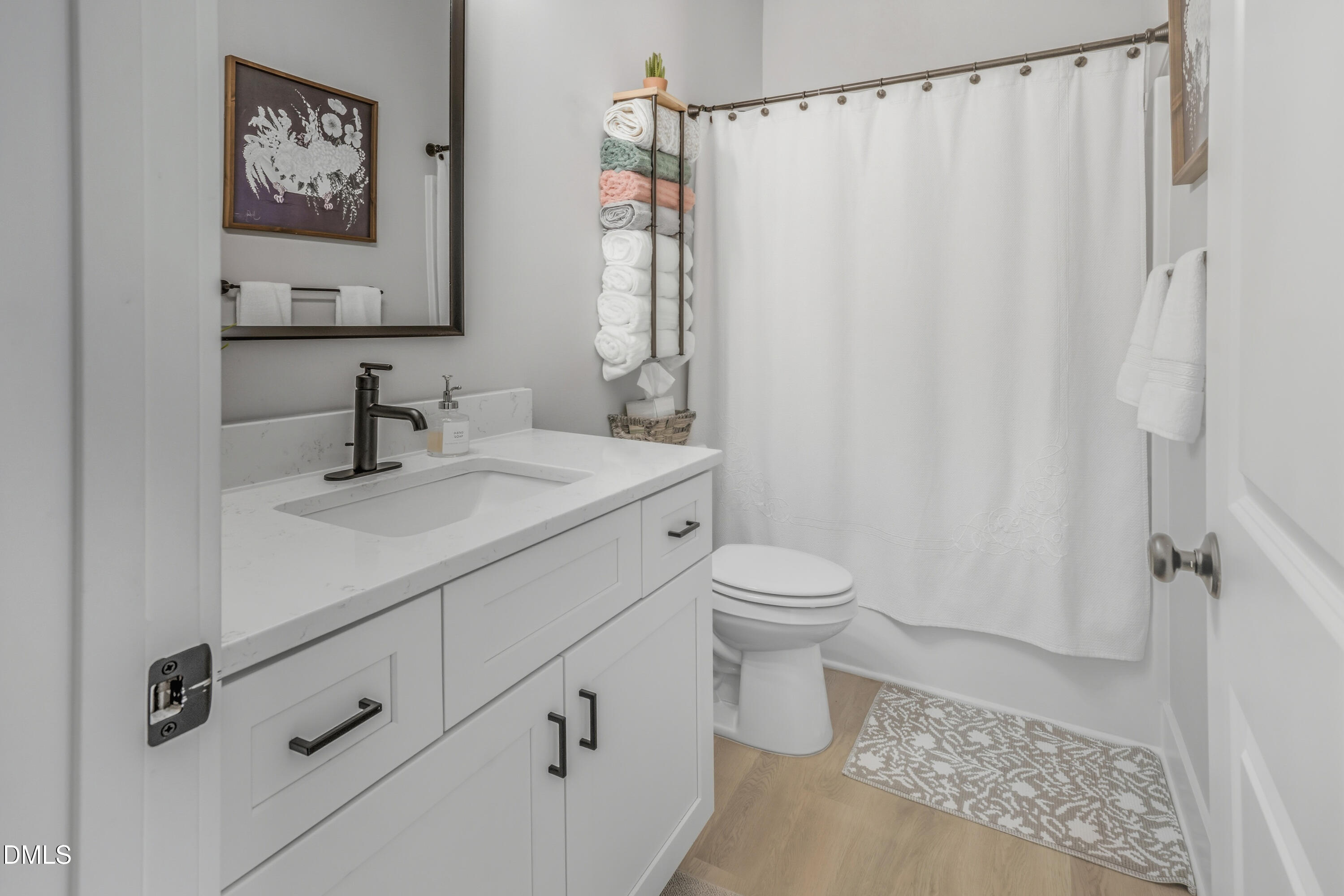 6039 Farmwood Loop Wilson, NC 27896 - Photo 19 of 27 a bathroom with a sink a toilet and shower curtain