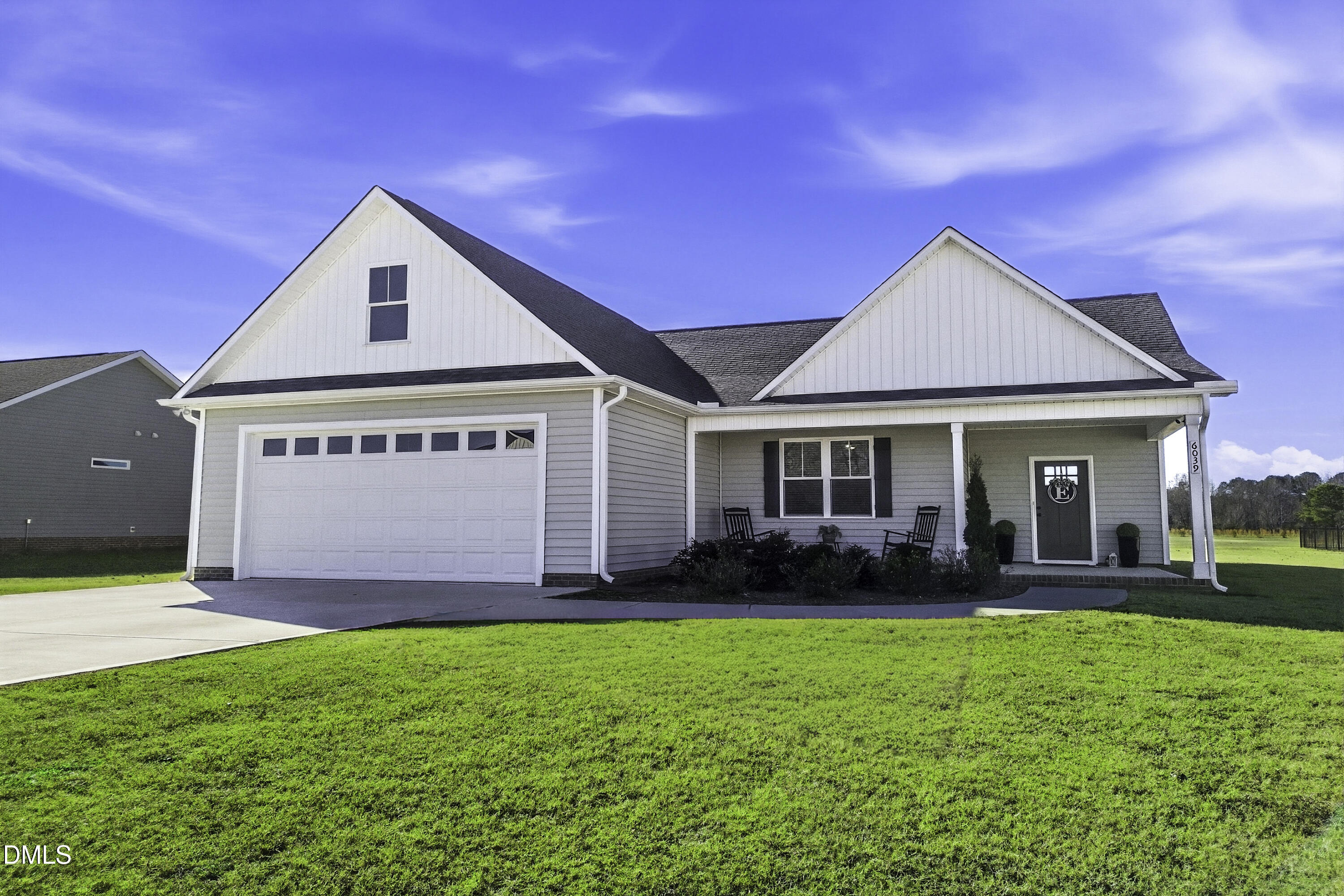 6039 Farmwood Loop Wilson, NC 27896 - Photo 25 of 27 a front view of a house with a garden and yard