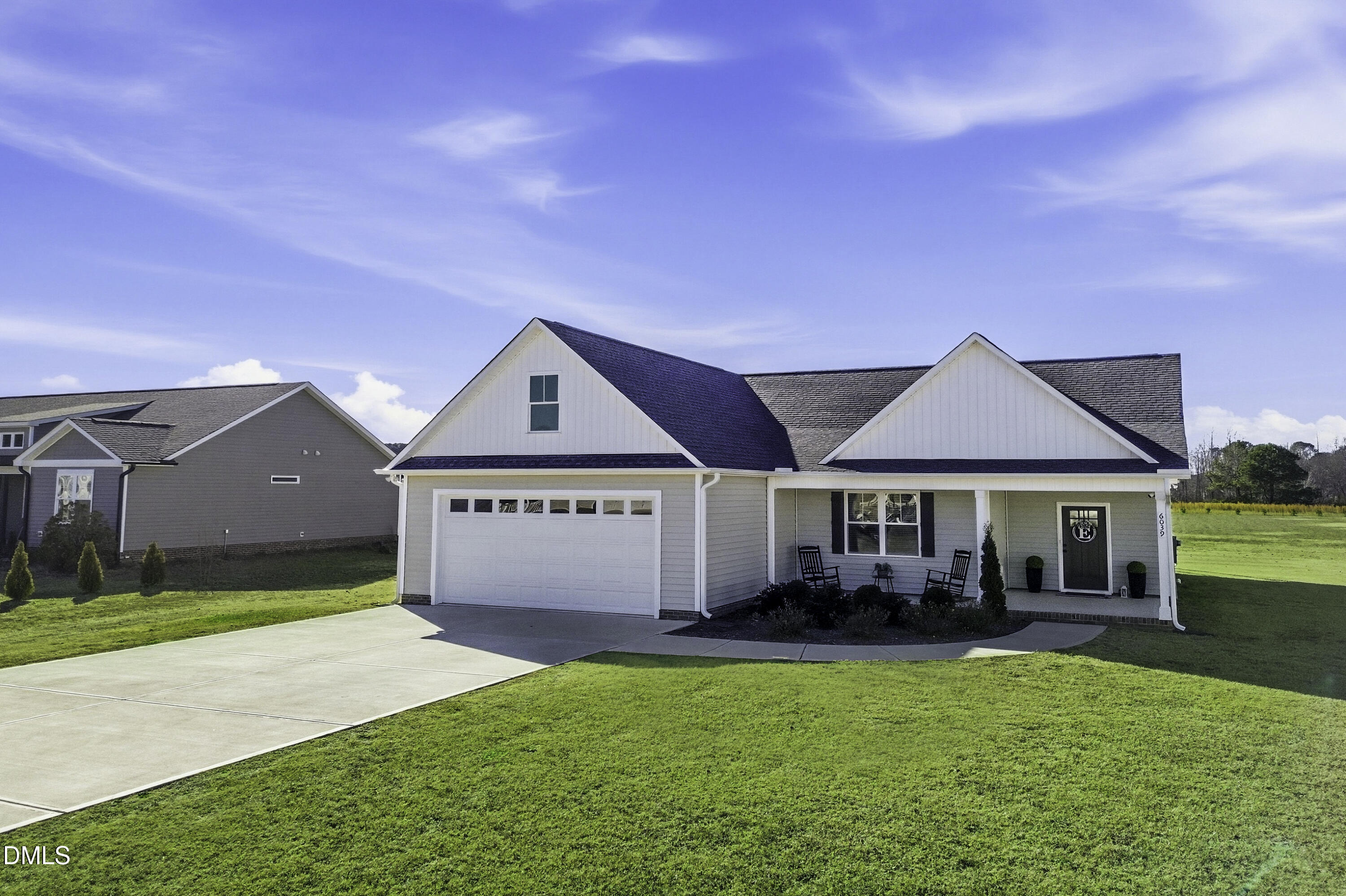 6039 Farmwood Loop Wilson, NC 27896 - Photo 26 of 27 a front view of a house with a yard table and chairs