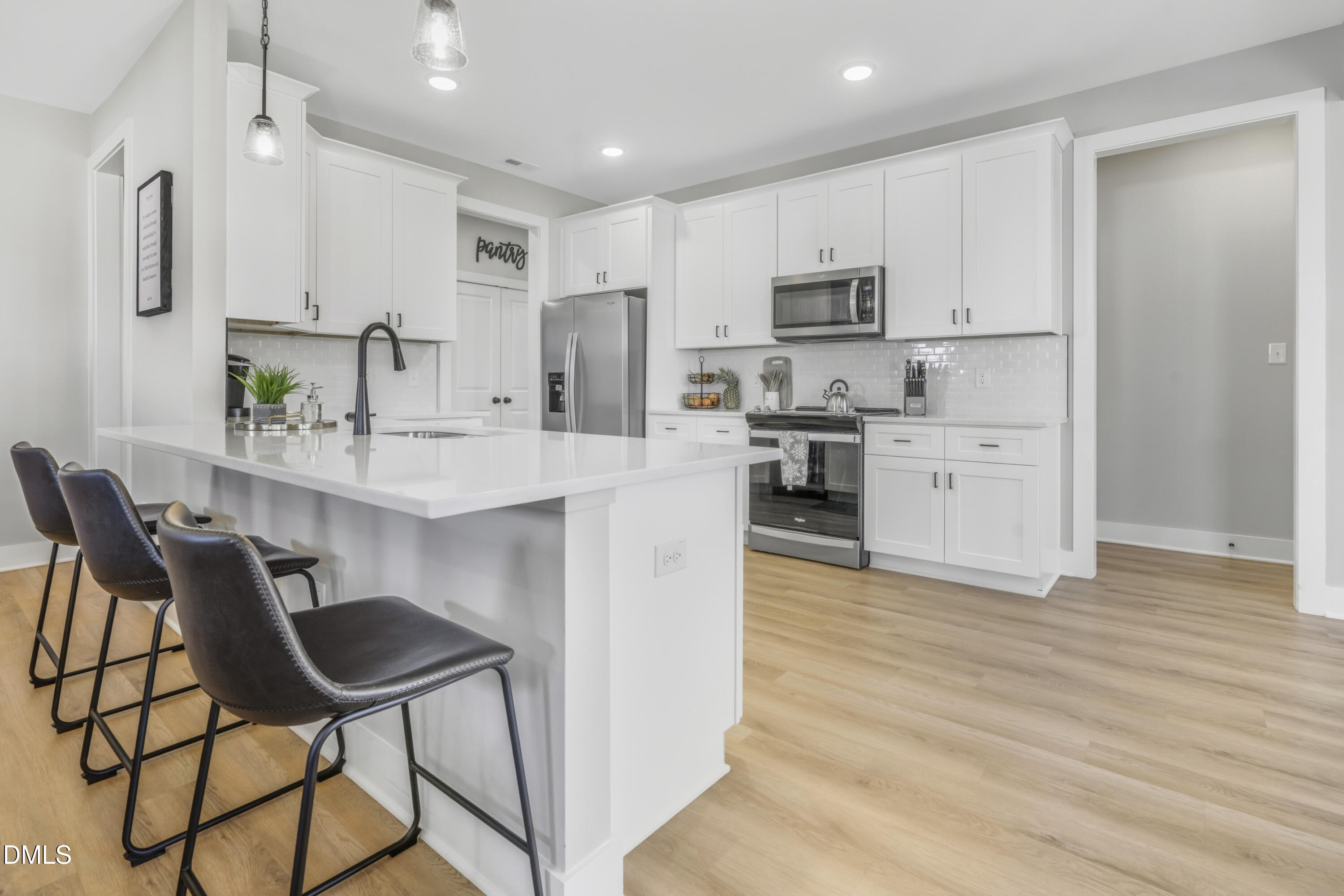 6039 Farmwood Loop Wilson, NC 27896 - Photo 8 of 27 a kitchen with stainless steel appliances kitchen island granite countertop a table chairs microwave and sink