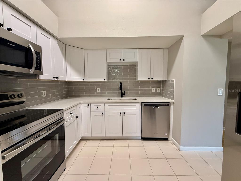 758 Warrenton Road Winter Park, FL 32792 - Photo 15 of 52 a kitchen with stainless steel appliances granite countertop a sink and a stove